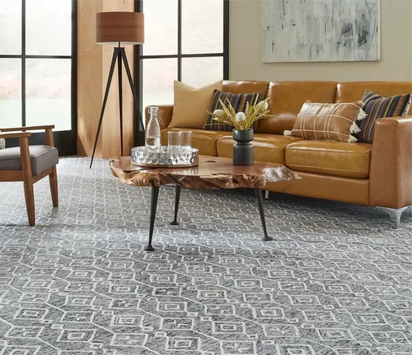 Grey geometric patterned carpet in a living room with a leather sofa and wood accents.