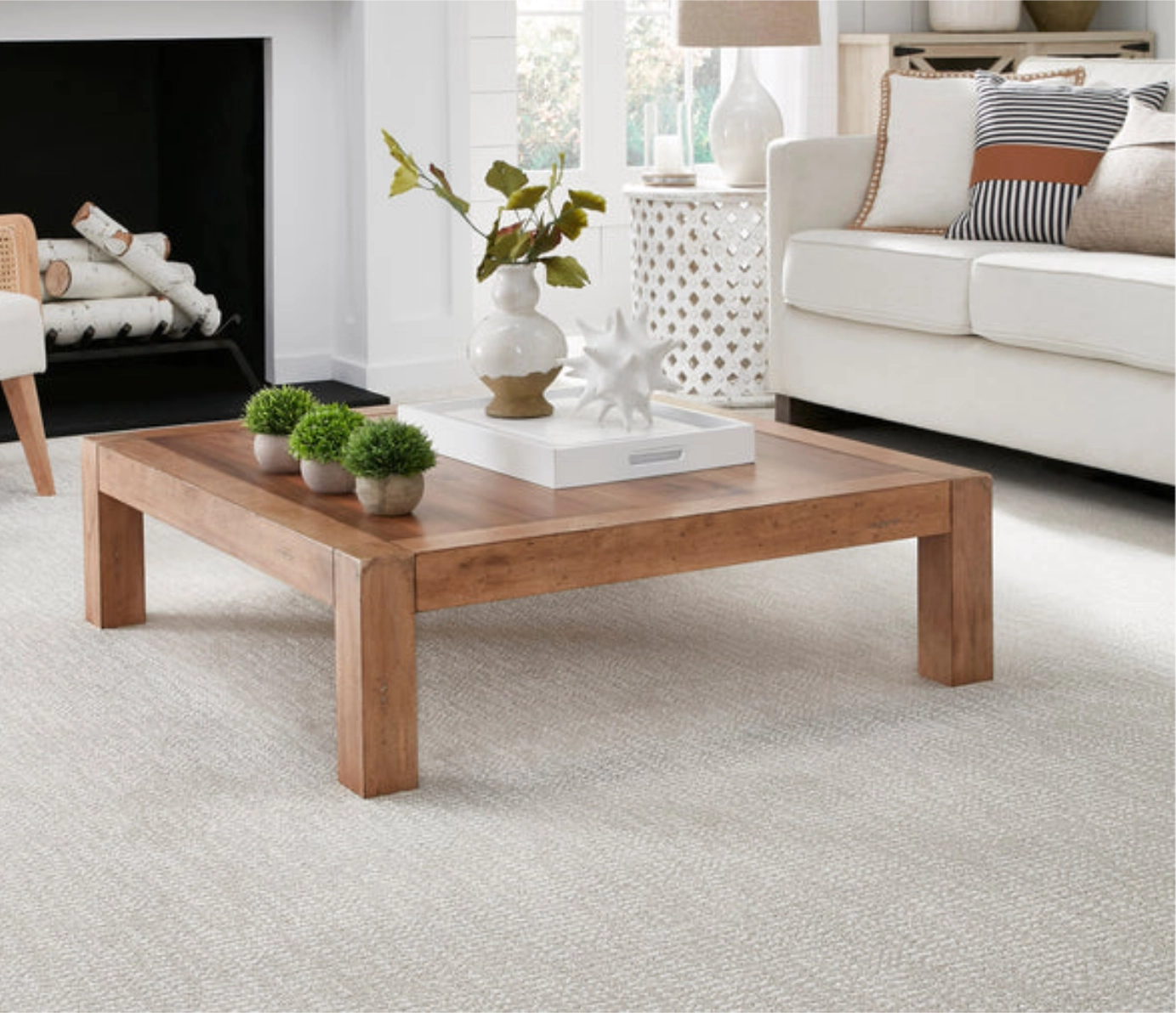 Light gray textured carpet under a wooden coffee table in a modern living room.