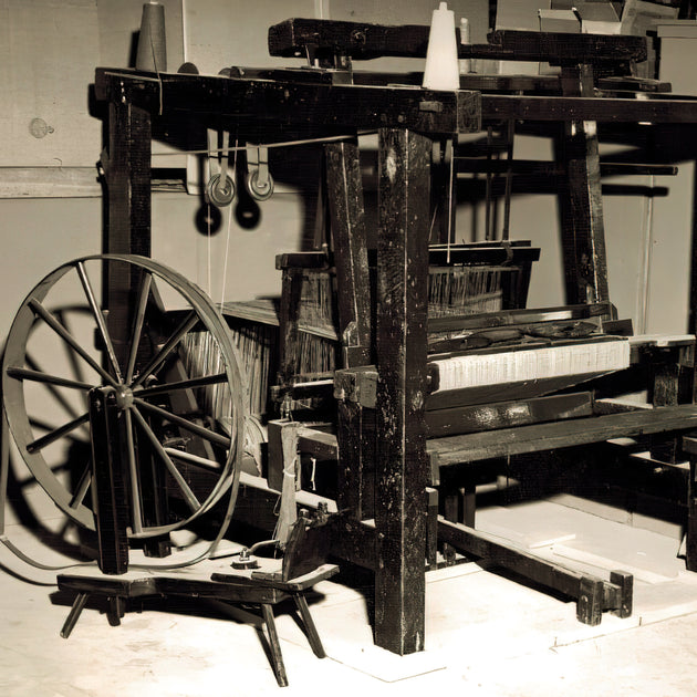 Vintage wooden weaving loom: Vintage wooden loom used for textile production.