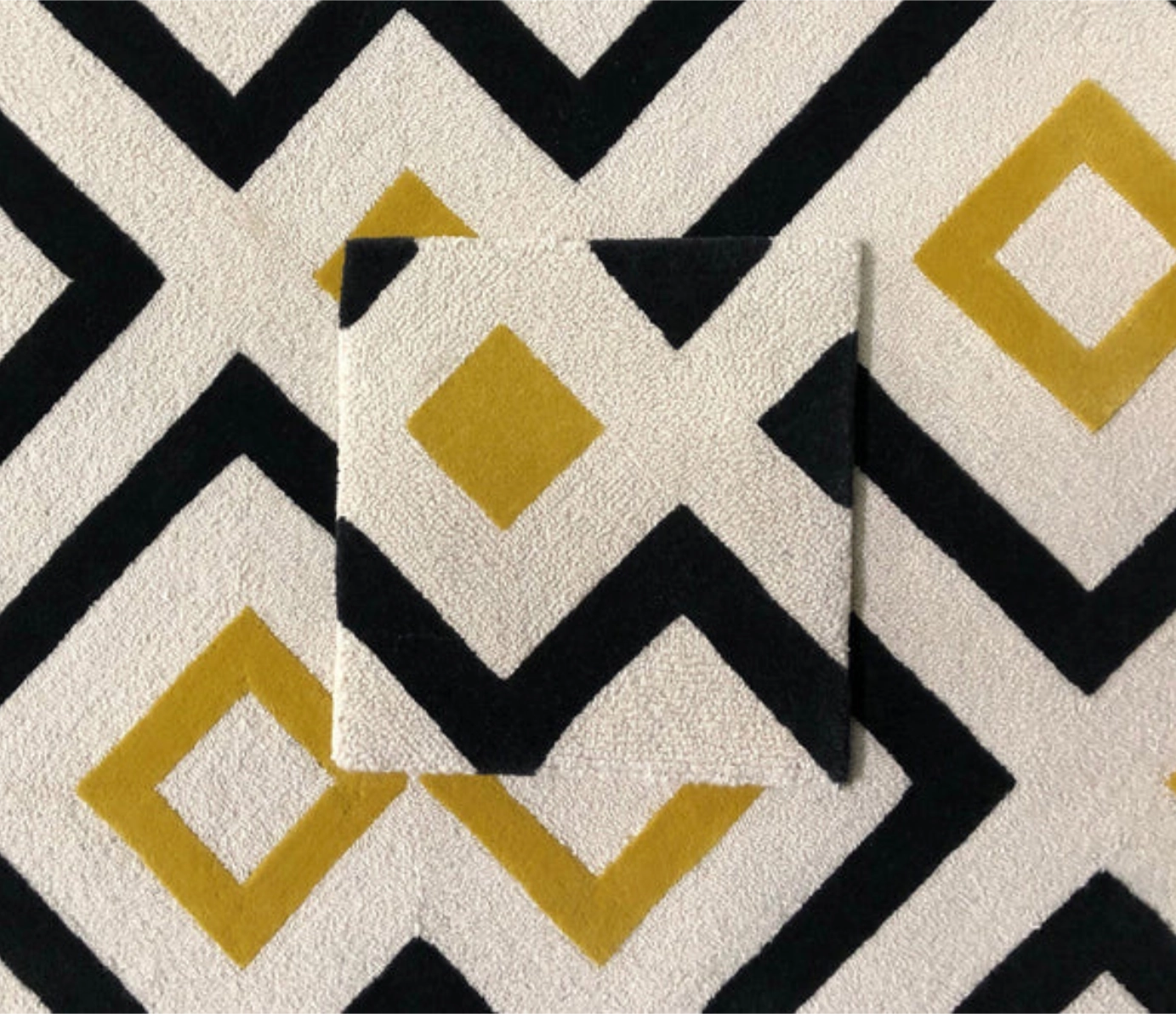 ample tile over a black, white, and gold geometric carpet pattern.