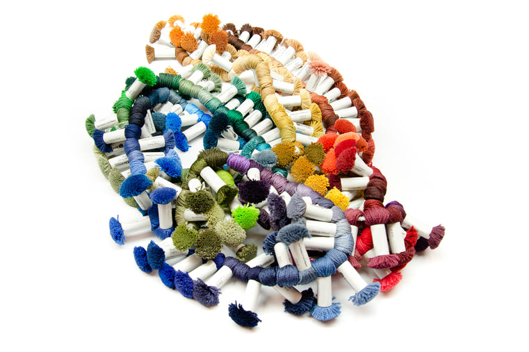 Colorful yarn swatches: Colorful yarn swatches arranged on a white background.