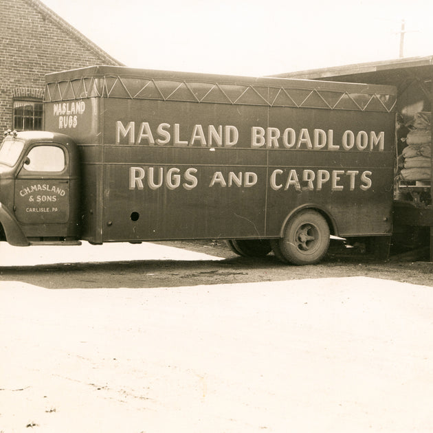 Vintage Masland delivery truck: Vintage C.H. Masland & Sons delivery truck parked outside a facility.